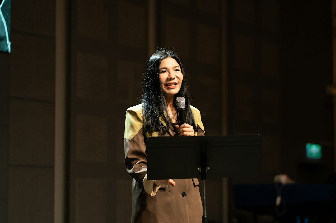 speaker with good posture on stage