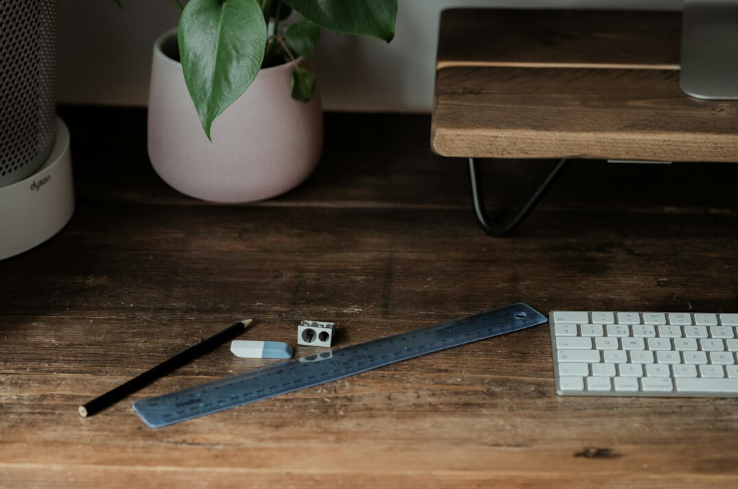 Notebook, pen and cup of coffee on a wooden desk