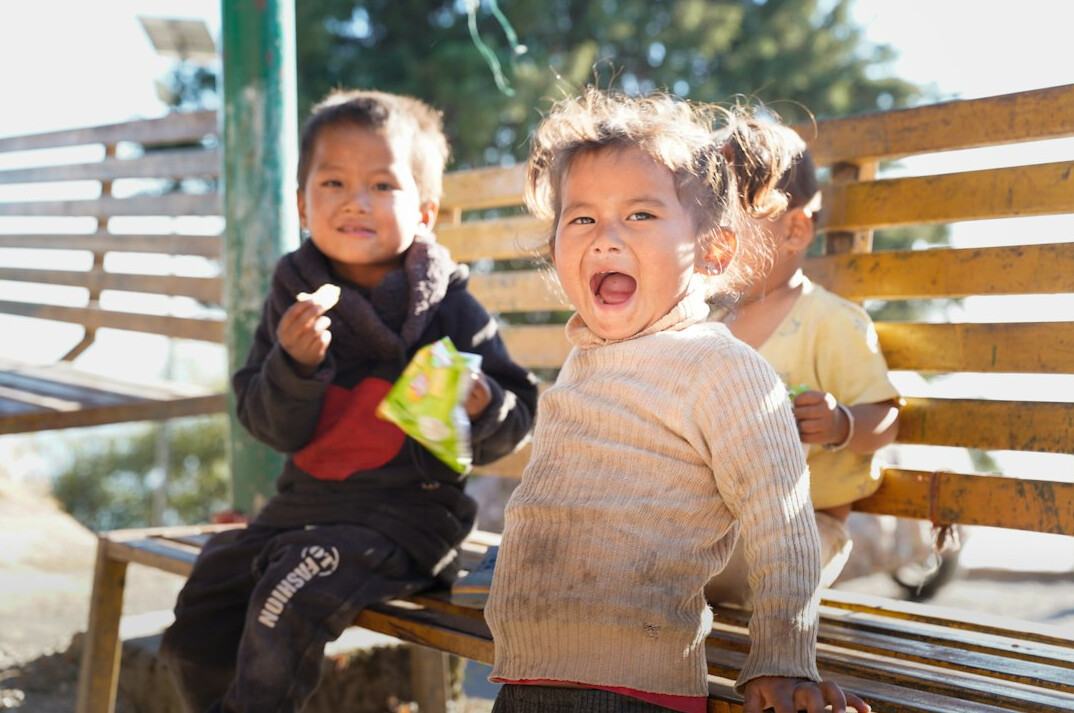 Small group of friends laughing together outdoors