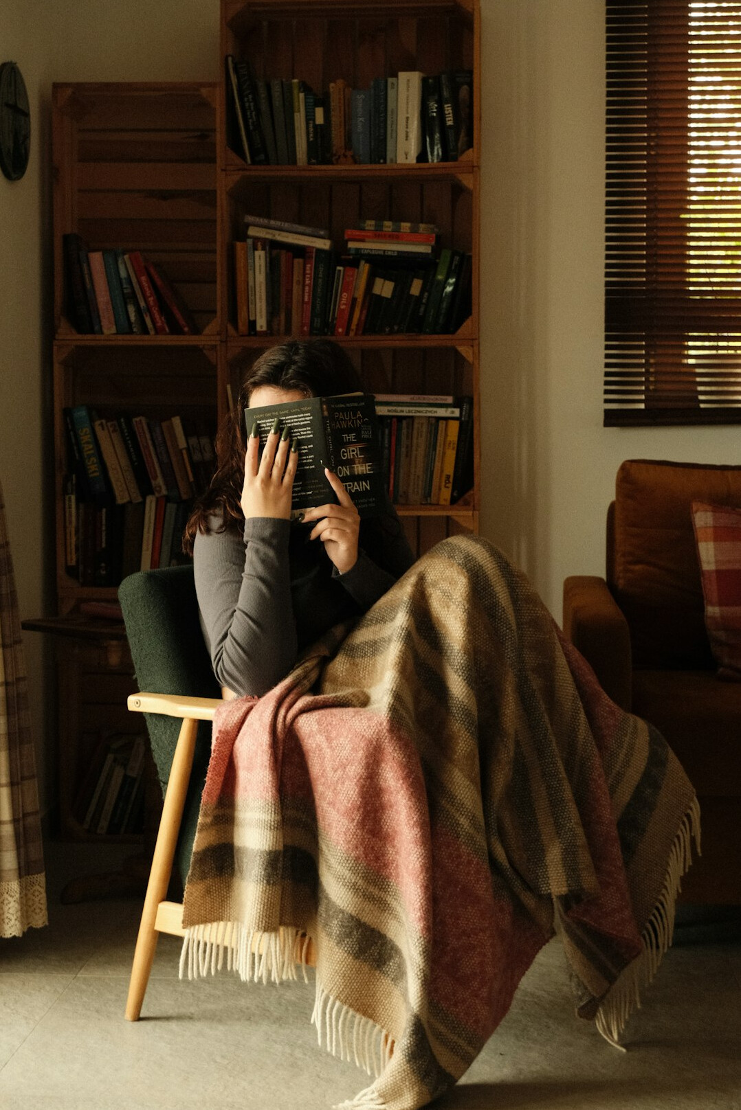 Person reading a book alone in a quiet room