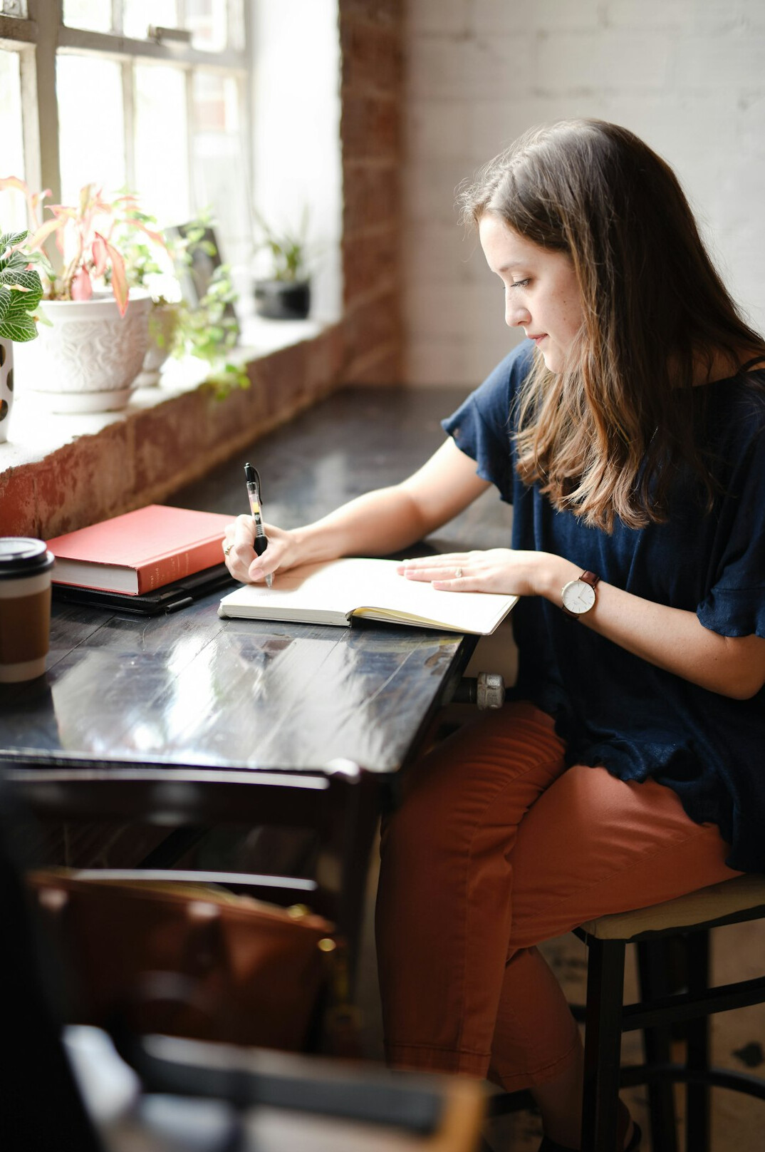 person writing in journal